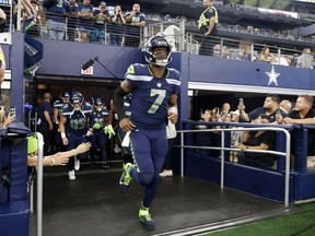 Seattle Seahawks quarterback Geno Smith leads the team onto the field or the first half of a preseason NFL football game against the Dallas Cowboys in Arlington, Texas, Friday, Aug. 26, 2022.