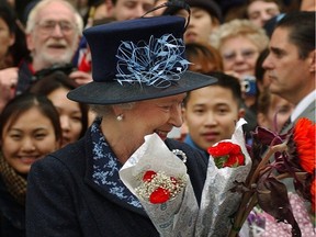 File photo of Queen Elizabeth II as she stopped to smell the flowers during a visit to U.B.C. in 2022.