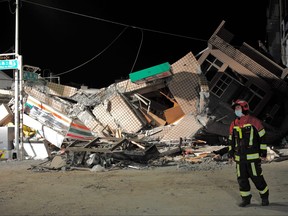 A rescuer walks past a collapsed building after an earthquake at Yuli Township in Hualien county, eastern Taiwan on Sept. 18, 2022.