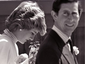 Princess Diana bows her head following Prince Charles on a walk to the California Pavilion in Vancouver May 6, 1986. (Mike Blake/Reuters)