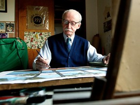 Artist EJ Hughes paints in his Duncan studio in 2004.