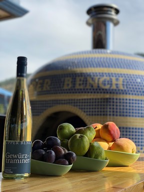 The pizza oven, a bottle of wine and freshly picked tree fruits at Upper Bench Estate Winery in Penticton. Photo: Shana Miller.