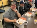 Vincenzo Milillo (left), who recently became homeless, said he is thankful he and the others at Union Gospel Mission's first sit-down Thanksgiving meal in three years are all still alive to enjoy it. Photo: Gord McIntyre.