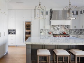A triangle-flecked tile backsplash (from the Liaison by Kelly Wearstler collection for Ann Sacks) adds  a fun visual detail amid the white-on-white finishes of the kitchen, while a custom hood fan and high-end appliances by Wolf and Sub-Zero elevate the feel.