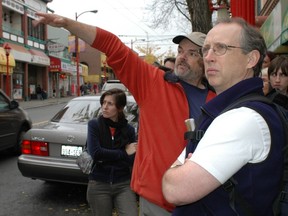 John Aktin (in red, with Terry Hunter on the right) and Bob Sung conduct a walking tour through Chinatown as part of this year's Heart of the City Festival.
