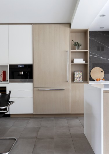 The kitchen features clean-lined modern cabinetry in oak and white.