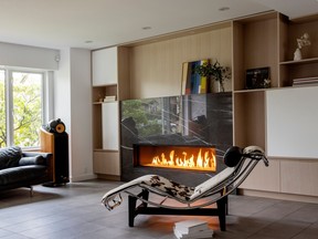 A black marble fireplace surround reflects light from outside, while the family's long-loved Le Corbusier chaise longue – and distinctive Bowers & Wilkins speakers – take pride of place in the living room.