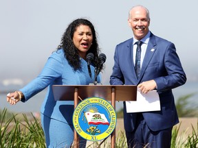 San Francisco Mayor London Breed and B.C. Premier John Horgan share a laugh during a news conference on climate change on Thursday, Oct. 6, 2022 in San Francisco.