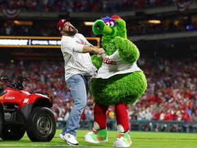 Philadelphia Eagles player Jason Kelce reacts with the Phillie Phanatic during game three of the National League Championship Series between the San Diego Padres and the Philadelphia Phillies at Citizens Bank Park on Oct. 21, 2022 in Philadelphia, Pennsylvania.