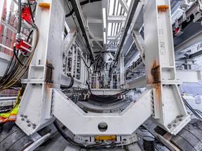 The steel gantry structure behind the tunnel boring machine. Once underground, the large wheels will rest on the completed tunnel section.