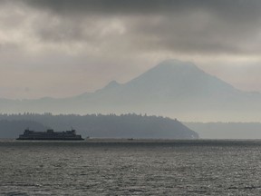A Washington State Ferry bound for Seattle passes Mt. Rainier in Washington's Puget Sound December 14, 2005.