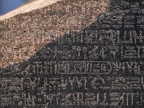 A close-up view of ancient Egyptian hieroglyphic text in the upper portion of the Rosetta Stone, on display at the British Museum in London.