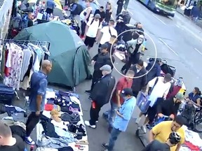 A still from video shows a suspect (circled) seconds after a man was shot with a crossbow at a Downtown Eastside street market.