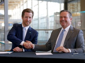 (L-R) WestJet CEO Alexis von Hoensbroech and Premier Jason Kenney shake hands after signing an agreement on new investments in the aviation, aerospace and logistics sectors at the Calgary International Airport in Calgary on Wednesday, October 5, 2022.