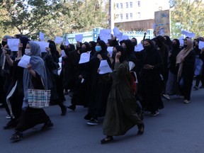 Afghan female students chant "Education is our right, genocide is a crime" during a protest as they march from the University of Herat toward to the provincial governor office in Herat on Oct. 2, 2022, two days after a suicide bomb attack in a learning centre in Kabul. Photo: Mohsen KARIMI/AFP via Getty Images