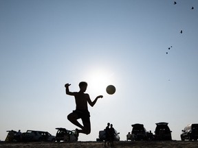 A visitor plays with a soccer ball at the Azerbaijan beach in Al Jassaiya, some 100 km north of Doha, on October 28, 2022, ahead of the Qatar 2022 FIFA World Cup football tournament. (Photo by Jewel SAMAD / AFP)