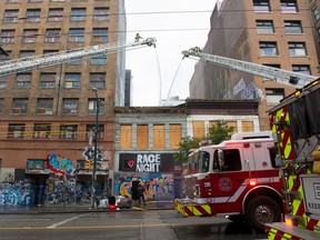 Fire crews spray water on a fire in the 100-block East Hastings Street in Vancouver on Oct. 25, 2022. Trax assignment ID# 00098195A.    Credit: Mike Bell