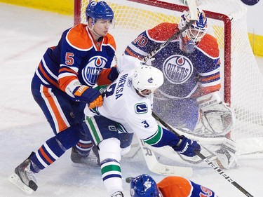 Edmonton's Ladislav Smid collides with Vancouver's Kevin Bieksa during the Edmonton Oilers game against the Vancouver Canucks at Rexall Place in Edmonton on Sunday, December 12, 2010.