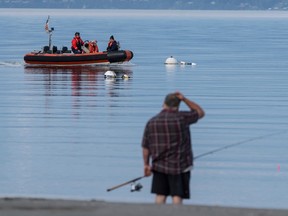 A U.S. Coast Guard vessel searches the area on Sept. 5 near Freeland, Wash., on Whidbey Island north of Seattle where a chartered floatplane crashed the day before. The plane was carrying 10 people and was en route from Friday Harbor, Wash., to Renton, Wash.