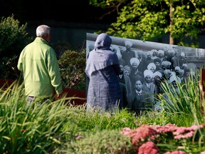 A couple stops to look at the Komagata Maru memorial in Coal Harbour August 23, 2021.