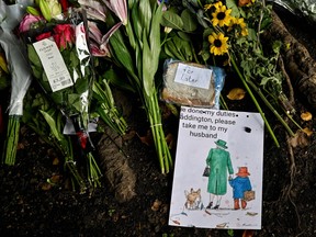 A drawing of Queen Elizabeth II and Paddington Bear is pictured next to a marmalade sandwich on a makeshift tribute by Buckingham Palace in London on Sept. 15, 2022.