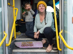 Melissa Denuzzo with Jun, 2, in the old bus they live in at Spanish Banks in Vancouver.