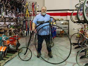 Grant Hobbis, owner of Cap's Bicycles, seen with a penny farthing bicycle hand-built by his father in the 1940's, is auctioning off his collection of vintage and collectible bicycles, dating from 1898.
