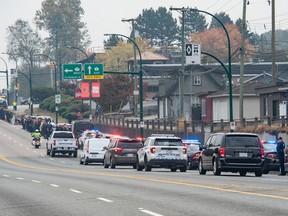 Police, emergency services personnel and the public line Grandview Highway in Vancouver, BC Thursday, October 20, 2022 to honour Const. Shaelyn Yang who was killed in the line-of-duty October 18 in Broadview Park in Burnaby, BC while helping a city by-law officer check-on a homeless man living in the park.