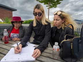 Paige Poorman draws out a backyard plan where her sister Chelsea was found. Chelsea’s mother Sheila Poorman, left, other sister Diamond spoke of how remains of the 24-year-old Cree woman were found outside a vacant mansion in Vancouver’s wealthy Shaughnessy neighbourhood earlier this year.