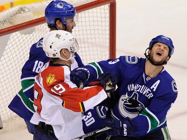 VANCOUVER  B.C.   January 8, 2015 Vancouver Canucks Kevin Bieksa 3, battles the Florida Panthers Scottie  Upshall 19, in Rogers arena in Vancouver  BC on January 8, 2015.  Roberto Luongo 1, was in net for the Florida Panthers.