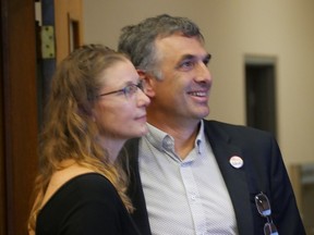 New Westminster mayor elect Patrick Johnstone and his partner, Antigone Dixon-Warren, watch the results of Saturday's voting at New Westminster City Hall.