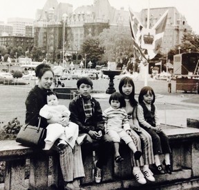 Baby Ken Sim sits on his mother Theresa’s knee, beside siblings Ed, Tina, Sabrina and Juliana while on a family trip to Victoria.