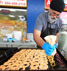 Bharboor Tumber makes Indian sweets for Diwali at the Ladoo Factory in Delta on Sunday.