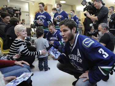 Vancouver Canucks' Kevin Bieksa  meets with sick children at the BC Childrens Hospital in Vancouver, BC., December 11, 2014.