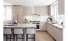 Kitchens feature high-end appliances integrated into flat-panel cabinetry.