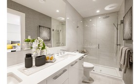 A frameless glass door opens up the spa-like ensuite bathroom space.