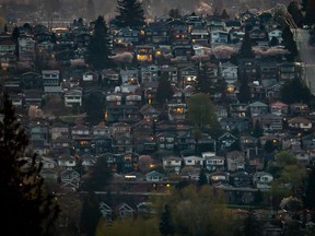 Houses are seen on a hillside in Burnaby, B.C., on Saturday, April 17, 2021. The Real Estate Board of Greater Vancouver says September's homes sales dropped by 46 per cent since last year and 10 per cent from August.