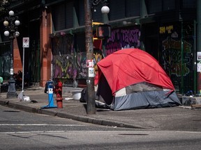A tent is seen on the sidewalk on East Hastings Street in the Downtown Eastside of Vancouver, on Thursday, July 28, 2022. A legal group in Vancouver says an order to remove tents on the Downtown Eastside is being challenged in B.C. Supreme Court.