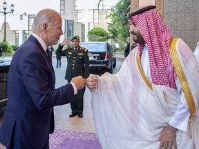 In this image released by the Saudi Royal Palace, Saudi Crown Prince Mohammed bin Salman, right, greets U.S. President Joe Biden with a fist bump after his arrival at Al-Salam palace in Jeddah, Saudi Arabia, on July 15, 2022.