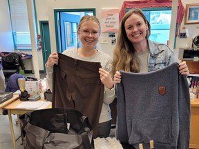 Teacher Kelsey Price (right) with colleague Janelle Lemoine sorting donated clothes for their students. Photo: Jean Kloppenburg.
