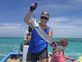 Mary Charleson shows off a baraccuda she caught off the shores of Belize during an adventure-packed girlfriends’ getaway.