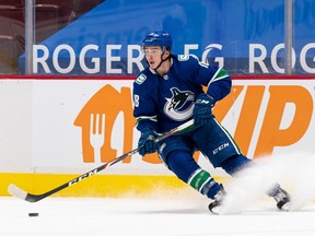 Former Vancouver Canuck Jake Virtanen skates with the puck in January 2021.