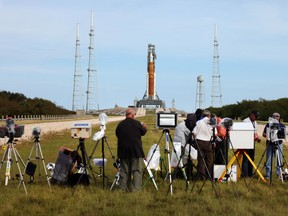 Members of the media set up cameras as NASA's Space Launch System (SLS) rocket with the Orion spacecraft attached rests on launch pad 39B as final preparations are made for the Artemis I mission at NASA's Kennedy Space Center on November 15, 2022 in Cape Canaveral, Florida.