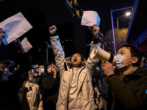 Protesters shout slogans during a protest against Chinas strict zero COVID measures on November 28, 2022 in Beijing, China. Protesters took to the streets in multiple Chinese cities after a deadly apartment fire in Xinjiang province sparked a national outcry as many blamed COVID restrictions for the deaths.