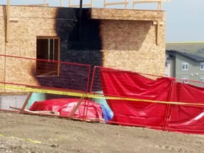 Burn marks from a vehicle fire mar the wall of a house under construction in northwestern Calgary on Monday, July 10, 2017. The Alberta Court of Appeal says the trial judge gave the jury misleading instructions about whether the murder of Hanock Afowerk was planned and deliberate.