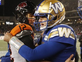 BC Lions quarterback Nathan Rourke (12) congratulates Winnipeg Blue Bombers quarterback Zach Collaros (8) on their Grey Cup Playoff victory at Investors Group Field.