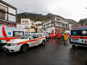 Emergency vehicles stand on a street, following a landslide on the Italian holiday island of Ischia, Italy, Nov. 26, 2022.