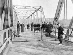 Fraser Street drawbridge looking north over the north arm of the Fraser River, Nov. 12, 1916. This photo ran in the Nov. 13, 1916 Vancouver Province, which identified the man on the right as bridge tender Thomas Dodson. The original Province cutline said the swinging draw of the bridge was only 10 feet from the gates - most of the men in the background are standing on the draw. Vancouver Archives AM54-S4-2-F1-: CVA 371-905.1