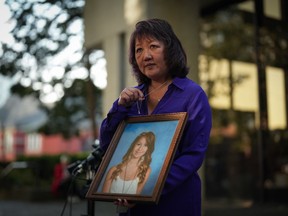 Carol Todd holds a photo of her late teenage daughter Amanda Todd, who died by suicide in 2012, and the necklace she was wearing in the school photo, outside BC Supreme Court after sentencing for the Dutch man who was accused of extorting and harassing her daughter , in New Westminster, BC, on Friday, Oct.  14, 2022.