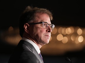 B.C. Health Minister Adrian Dix pauses while responding to questions during a news conference with his provincial counterparts over this week's health-care meeting.
